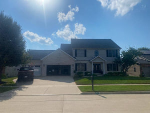 Homeowner documenting storm damage for a roof insurance claim in Illinois with an inspector on the roof