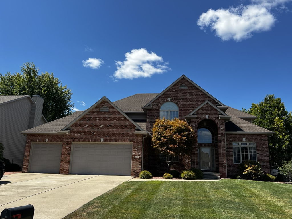 Aging asphalt shingle roof on a Central Illinois home showing how long a roof lasts in Illinois weather