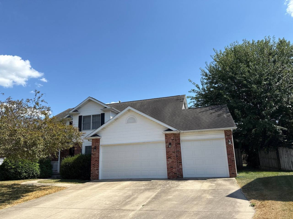 Ridge cap shingles installed along a roof peak in Central Illinois